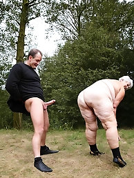 British MILF with big tits and slicked hair poses in a seductive manner